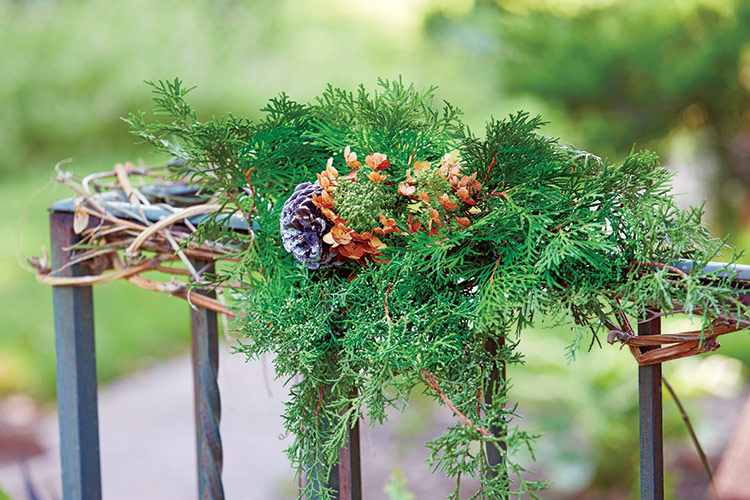 DIY holiday decor tip lead: Wind several vines through the railing to create a framework for other stems.