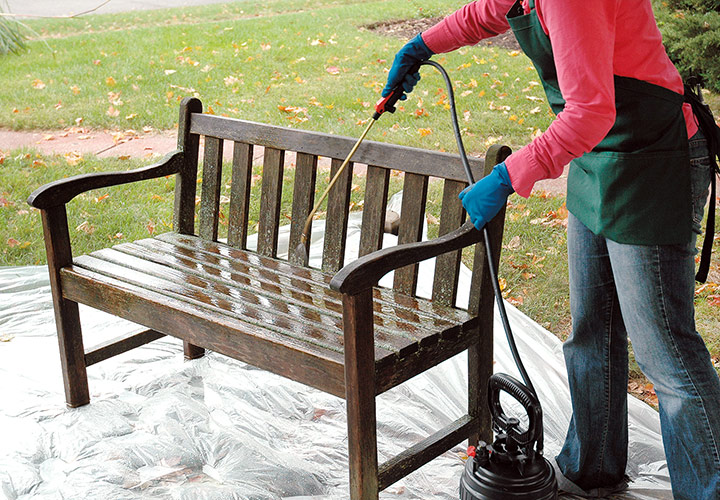 Spray wooden bench with wood brightener: After spraying down your wooden furniture with water from the garden hose, spray a fine mist of wood brightening solution all over the bench.