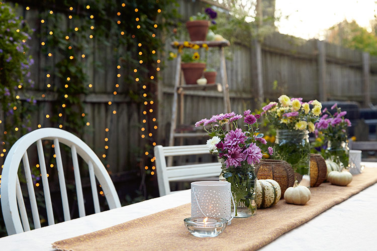 budget-friendly-table-setting-garden: Make a budget-friendly table runner by folding over and pressing a piece of fabric. It’s easy to swap out different swatches to change the look each season. 