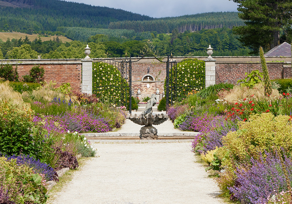 Ireland Powerscourt Estate double border pathway Lead: Double perennial borders are a classic European garden design element.