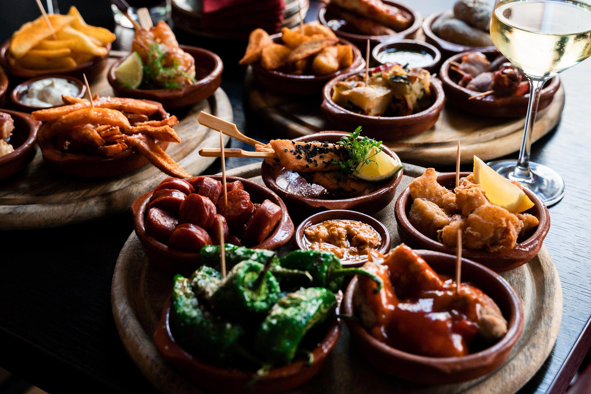 Tapas bowls with food arranged on a table in a tapas bar