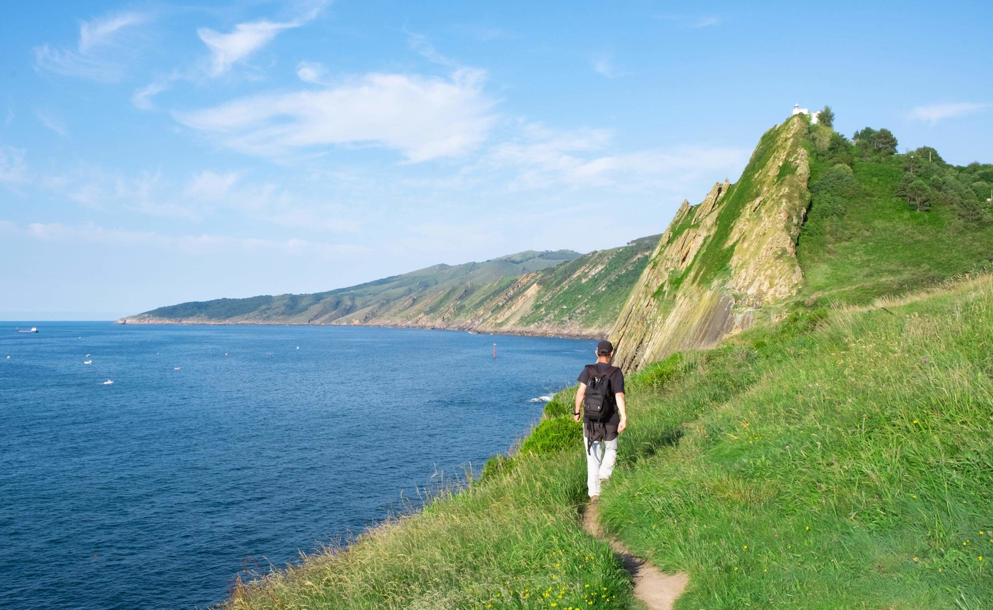 Hiker exploring Mount Ulia's cliffside route