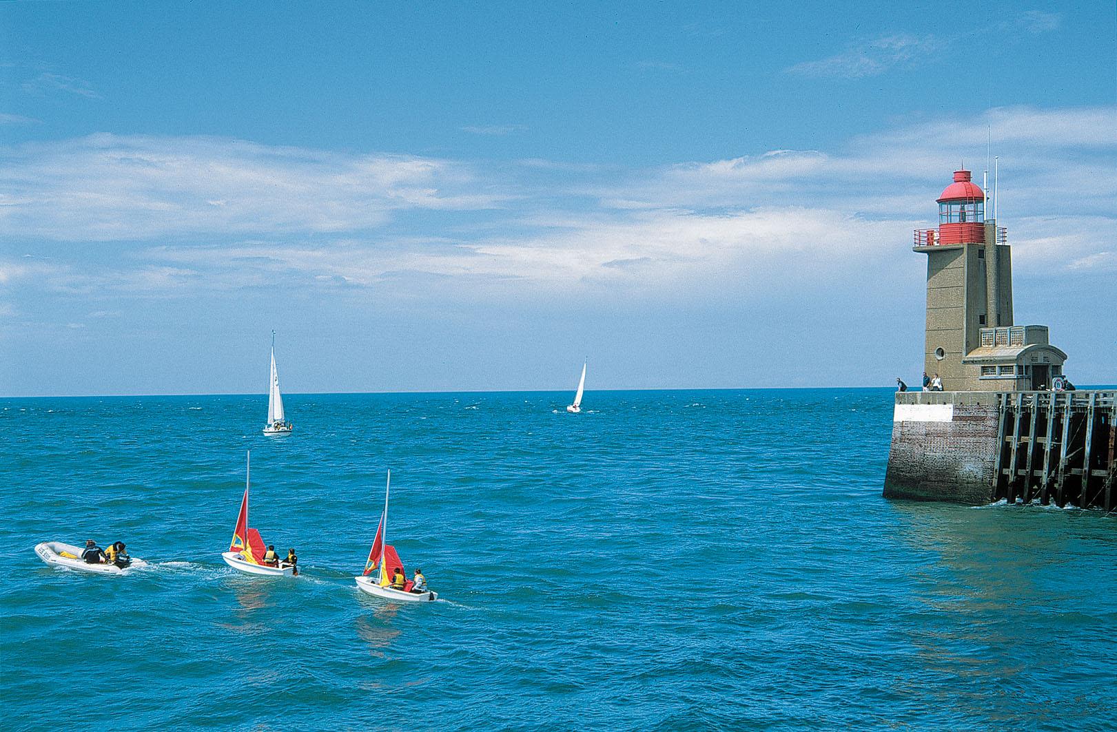 Sailing boats under tuition passing Fecamp lighthouse CRT Normandy