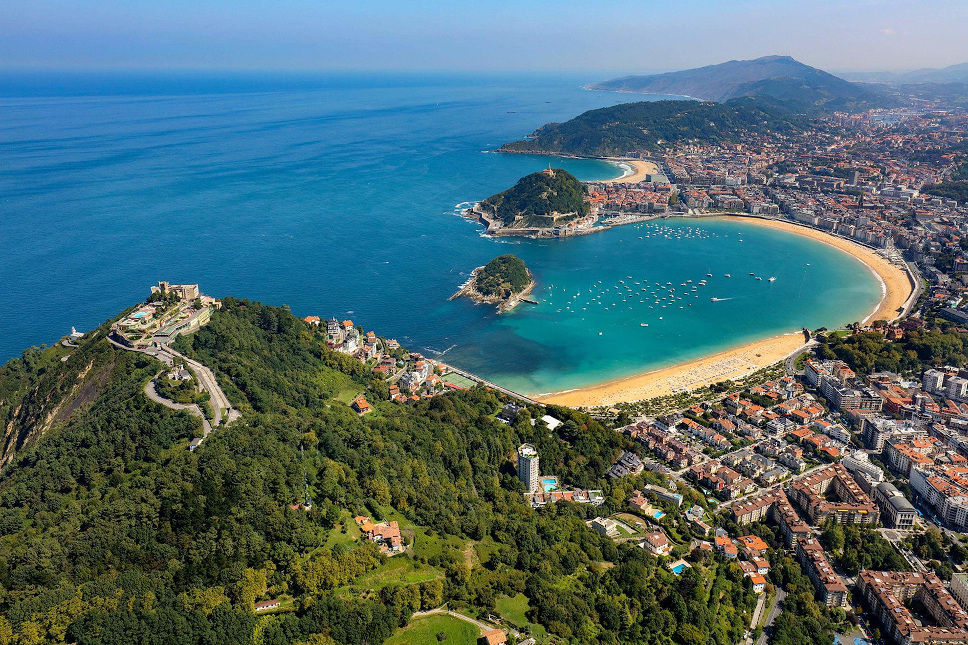 Aerial view of La Concha bay with its golden beaches © @donostiaturismoa