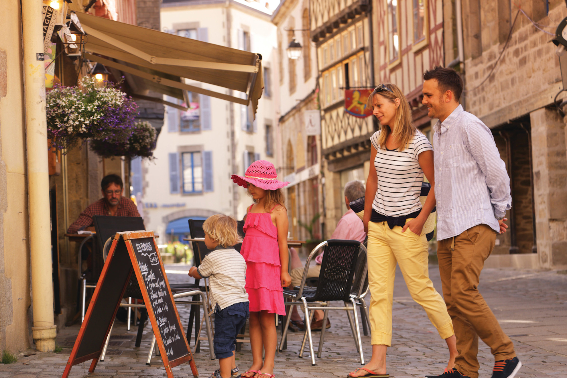 Family outside a restaurant looking at the menu board