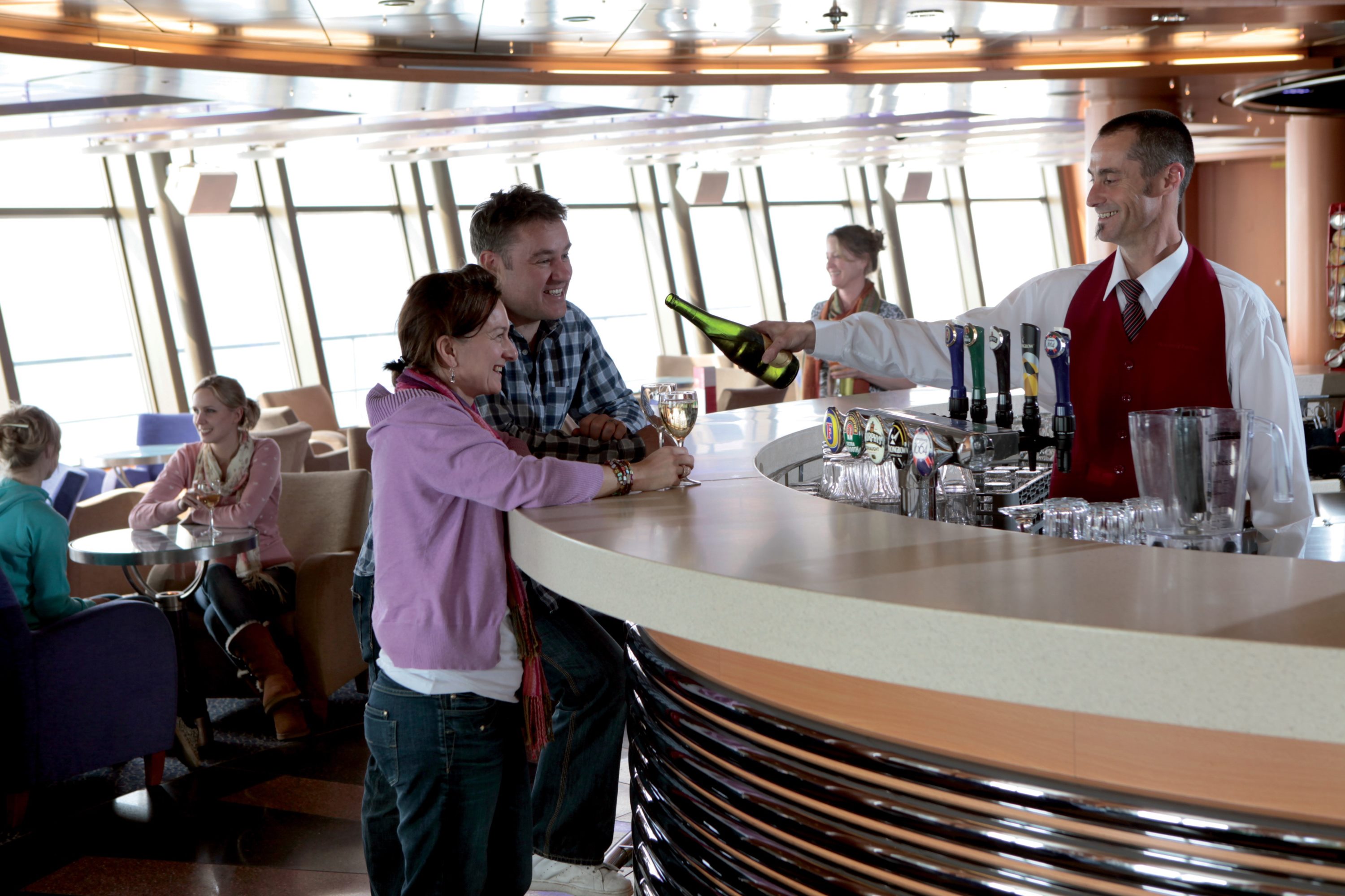 Couple getting a drink a the bar onboard