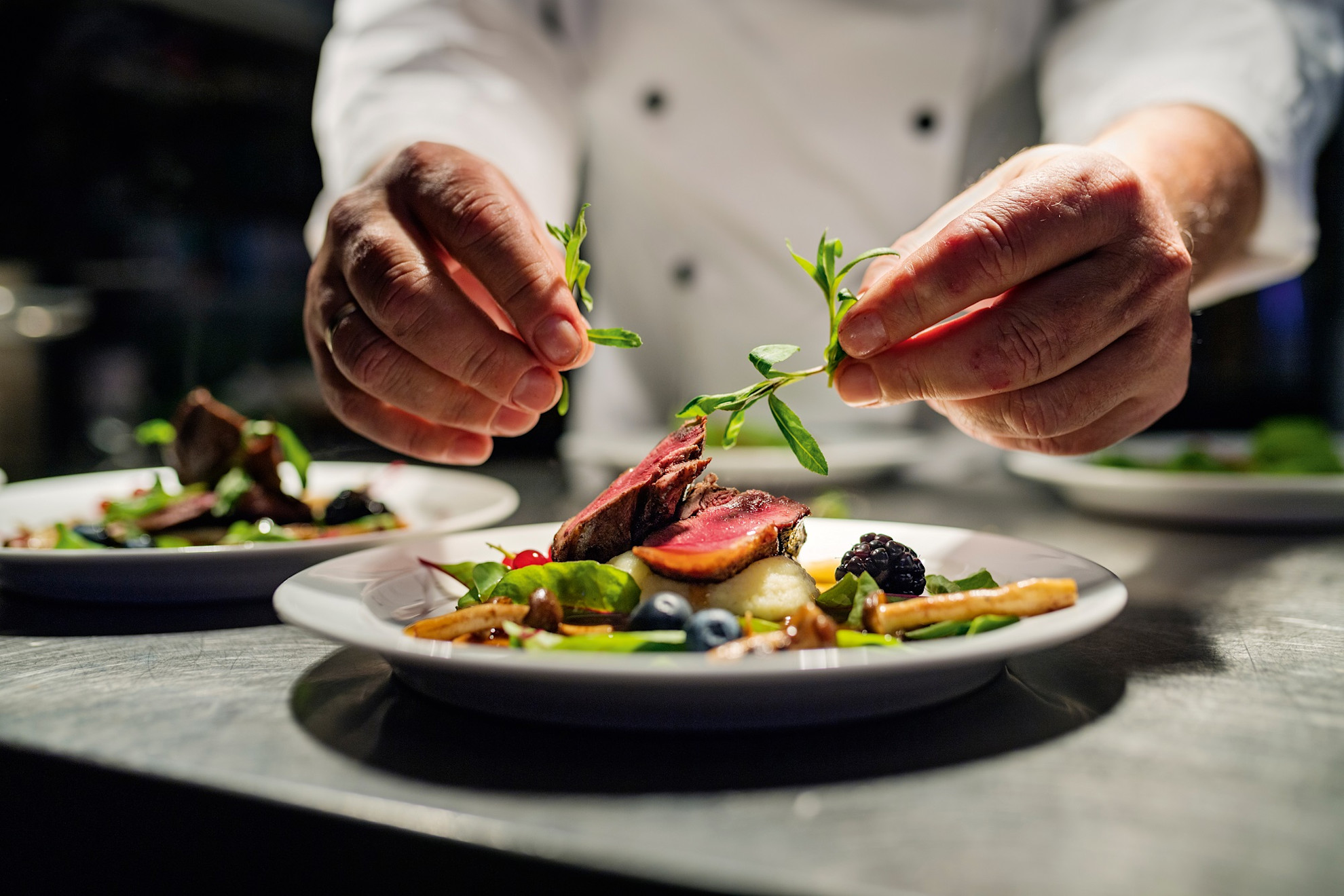 Chef adding finishing touch to a dish