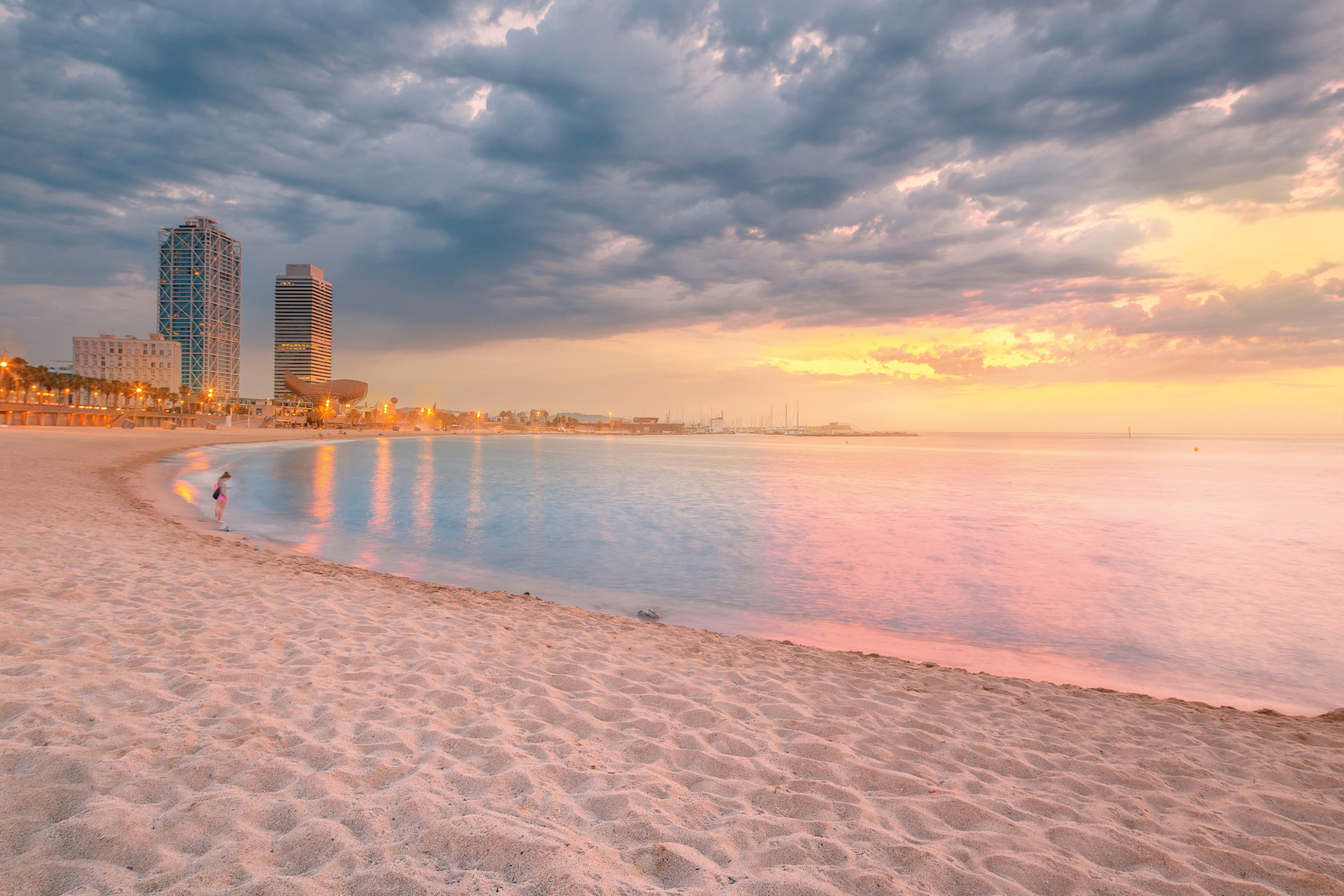 Barceloneta beach in Barcelona with colorful sky at sunrise