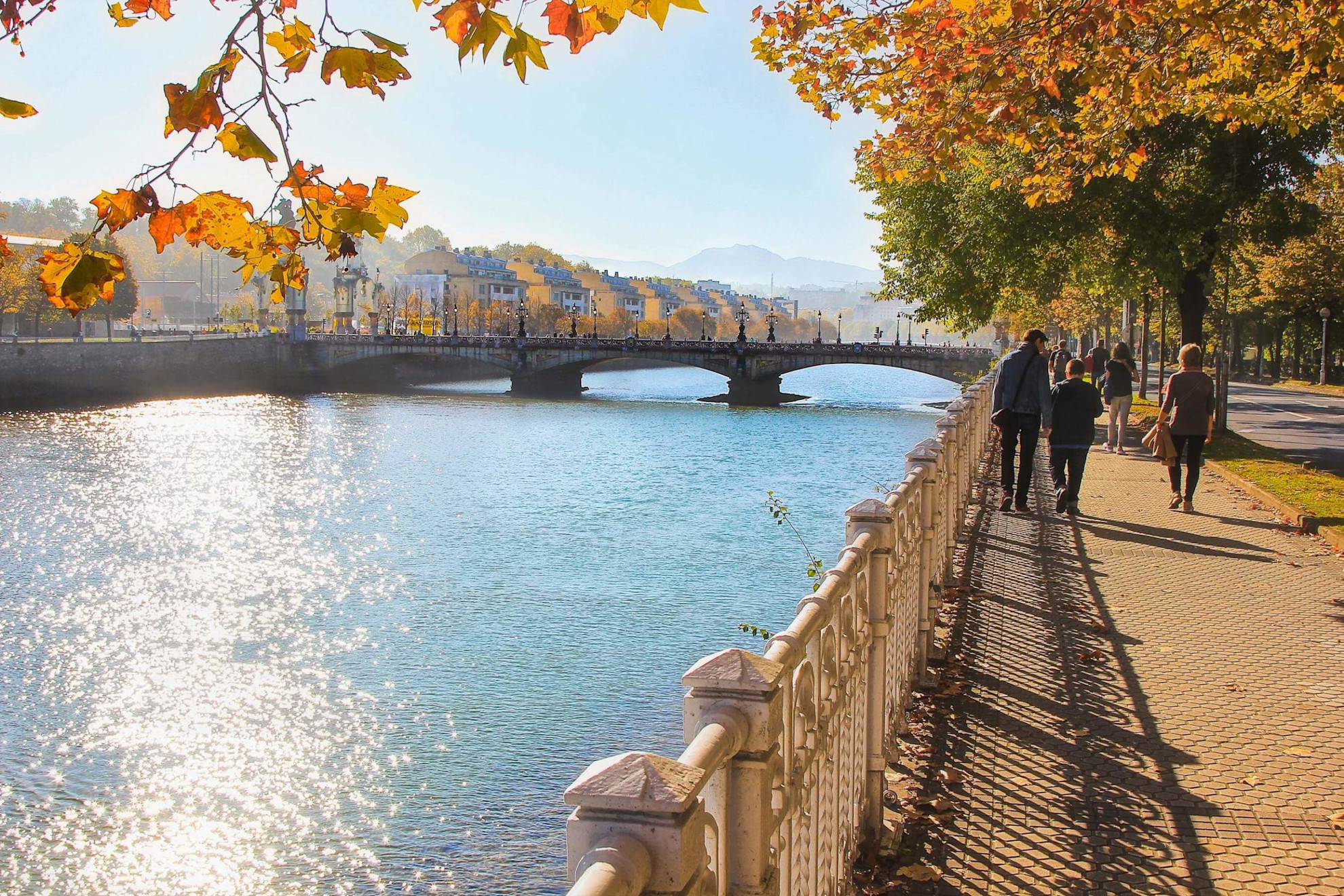 Pretty riverside walk towards Maria Cristina bridge