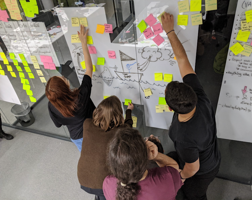 The team filling out the sailboat