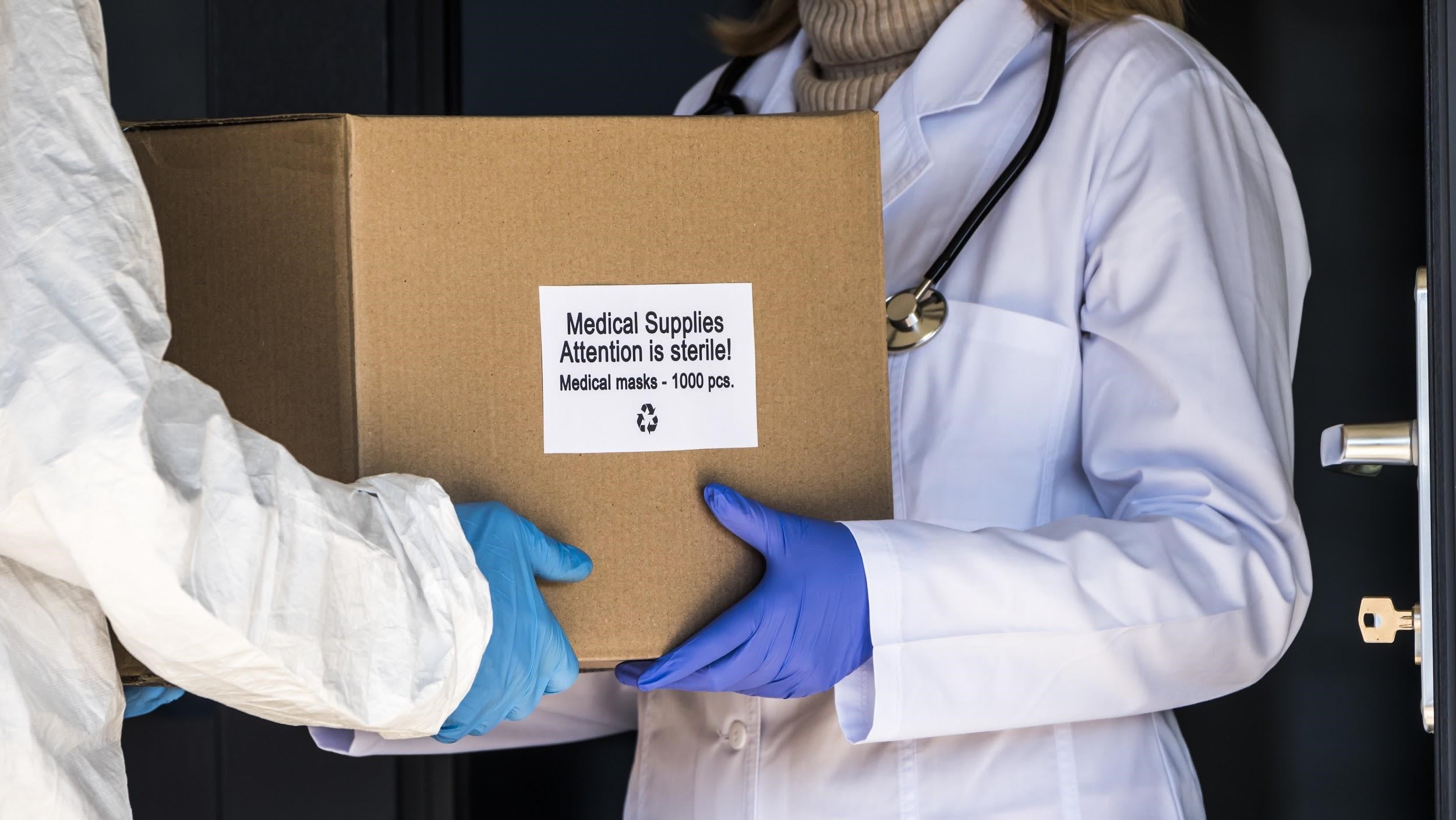 Medical staff passing a box