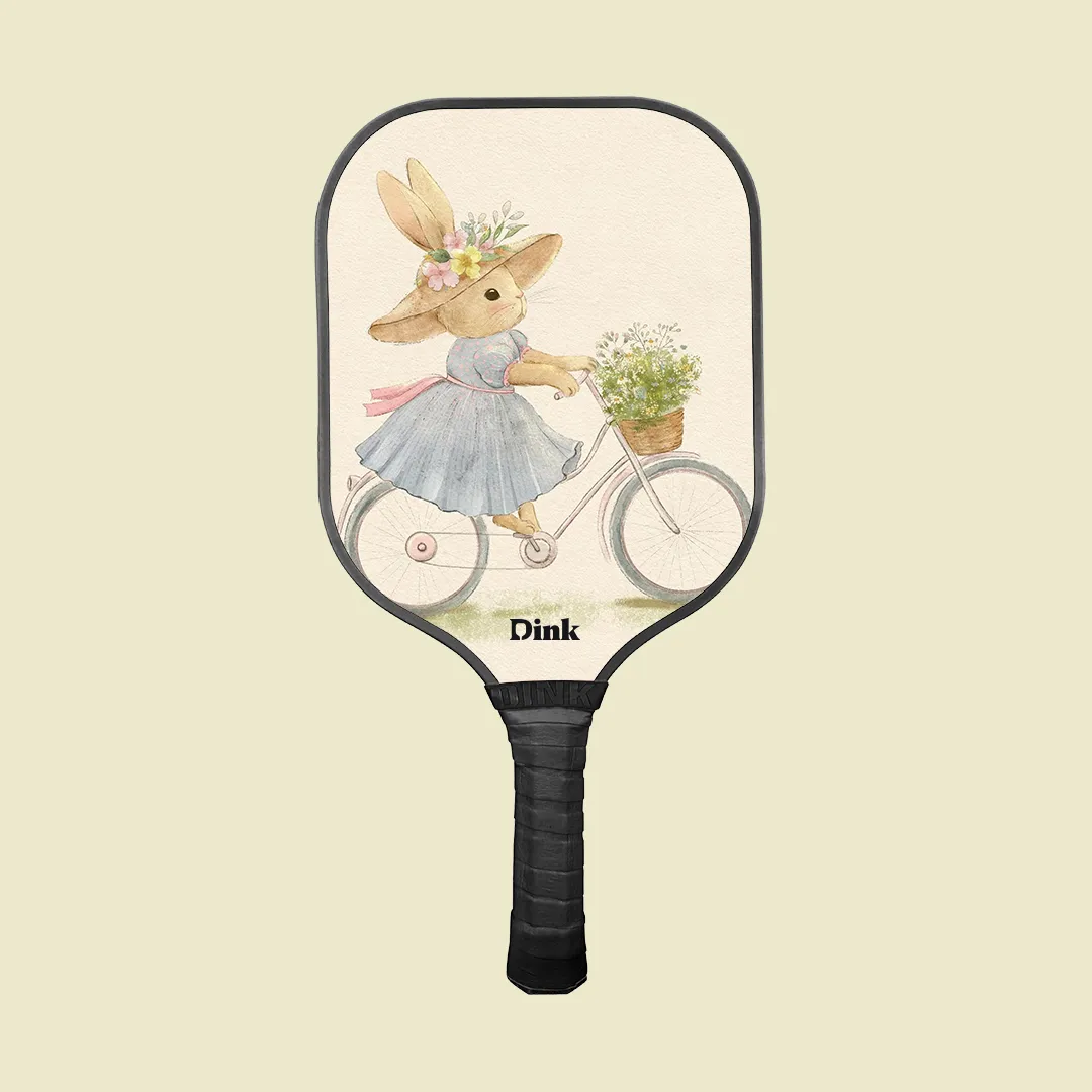 dink´s custom pickleball paddle with a cute vintage rabbit on a bicycle