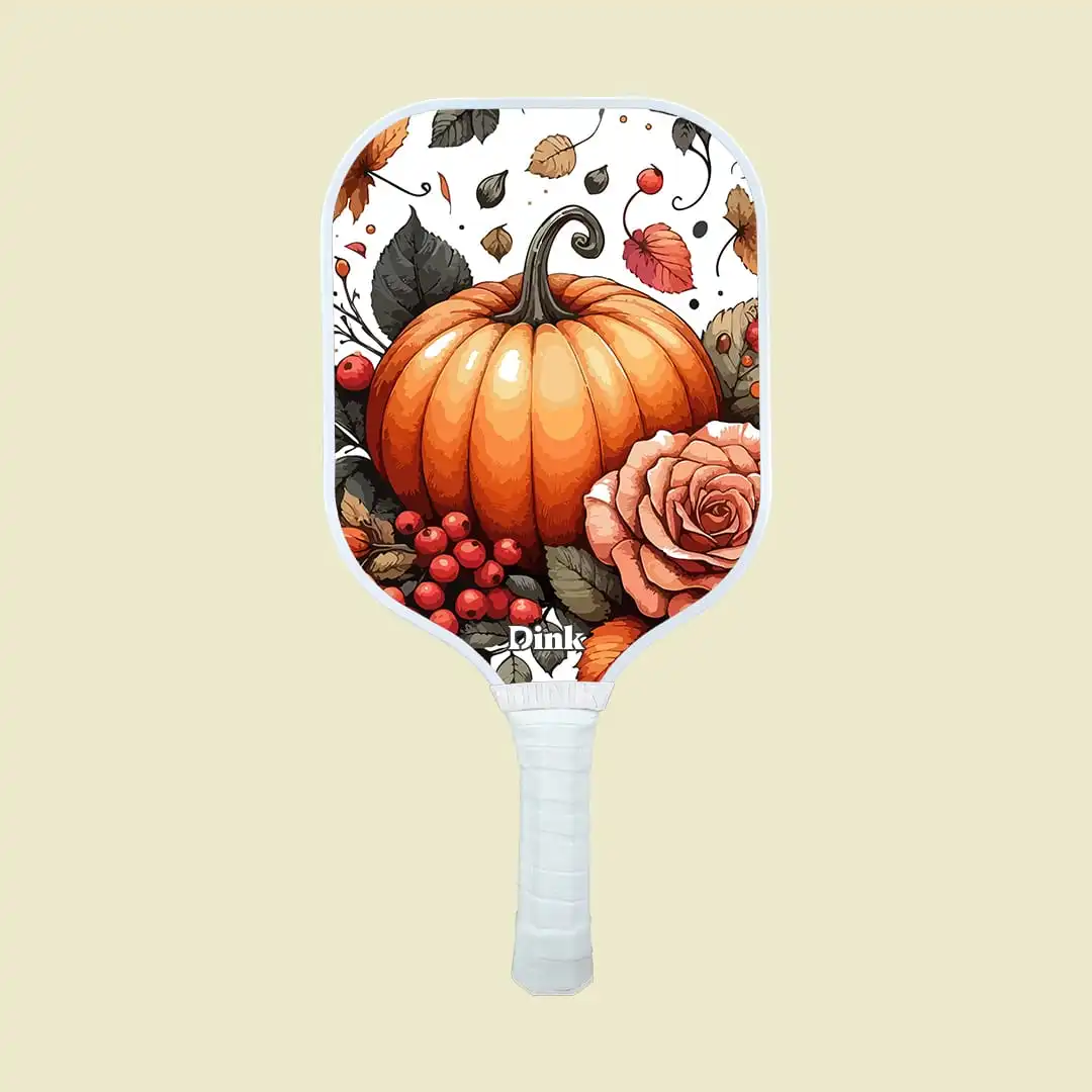 a pickleball paddle with autumn leaves and pumpkins design