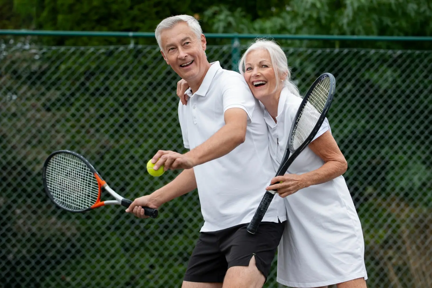 Two senior pickleball players on the court