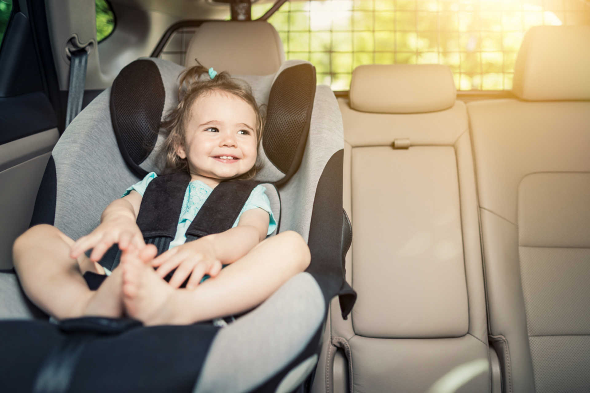 stock-photo-beautyful-smiling-baby-girl-fastened-with-security-belt-in-safety-car-seat-693112123