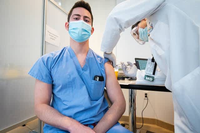 person getting covid-19 vaccine