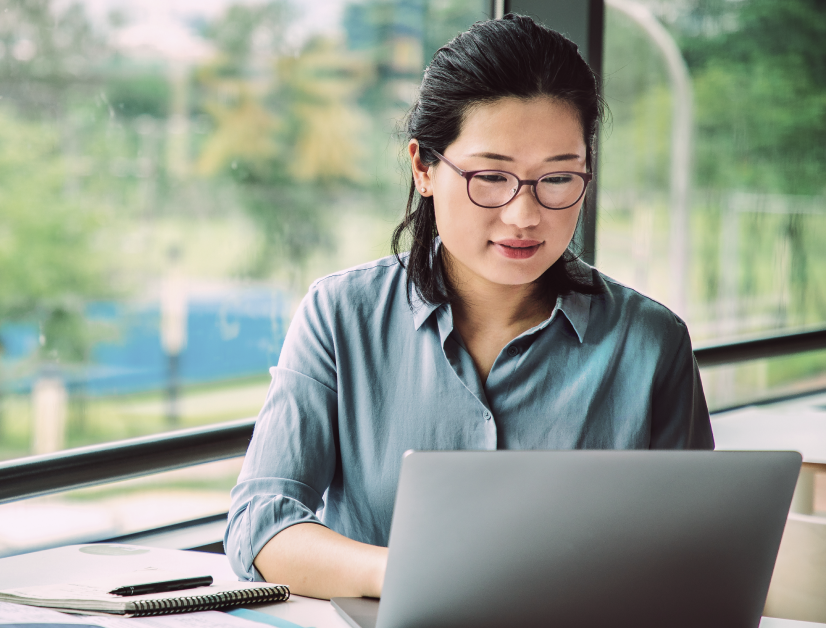 A woman looking at her laptop