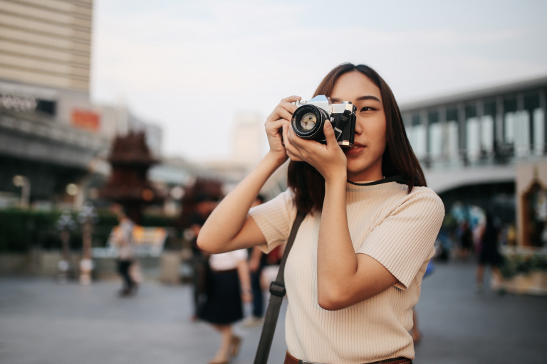 A young woman taking a photo with her camera