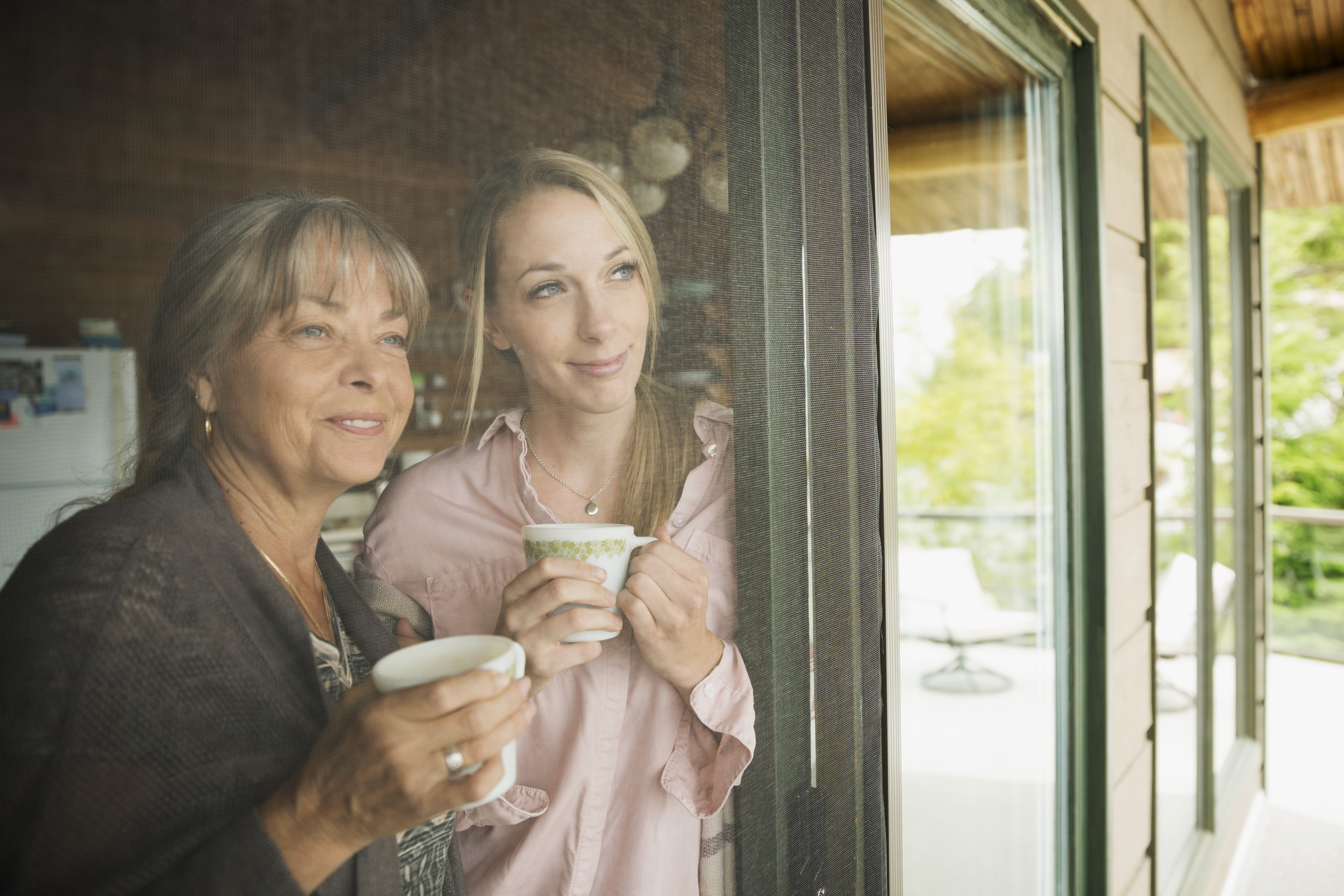 Woman and her mother looking out the window