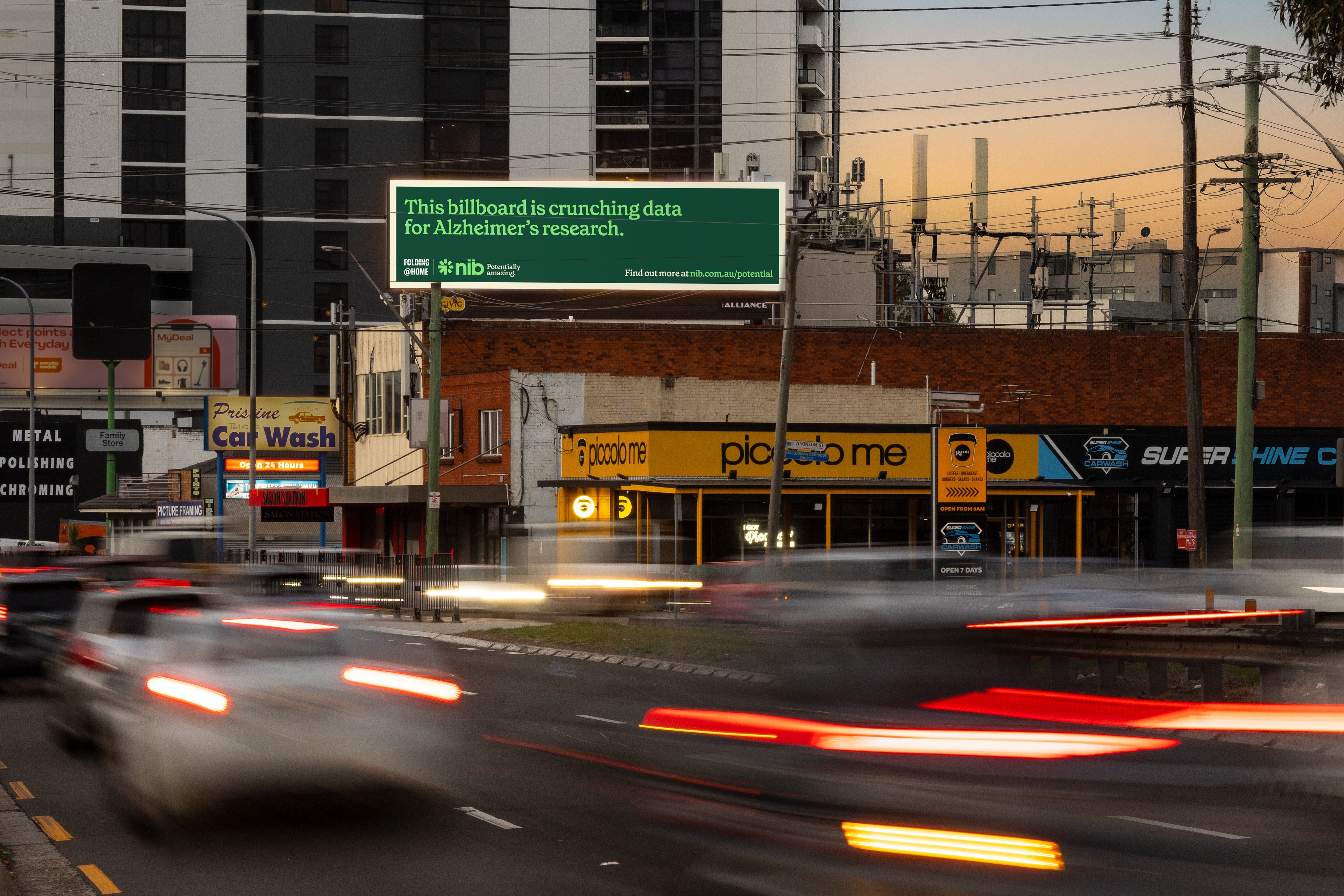 Horizontal nib billboard print ad above busy road that reads: "This billboard is crunching data for Alzheimer's disease"