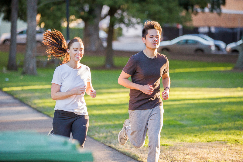 Female and male running in the park at daytime