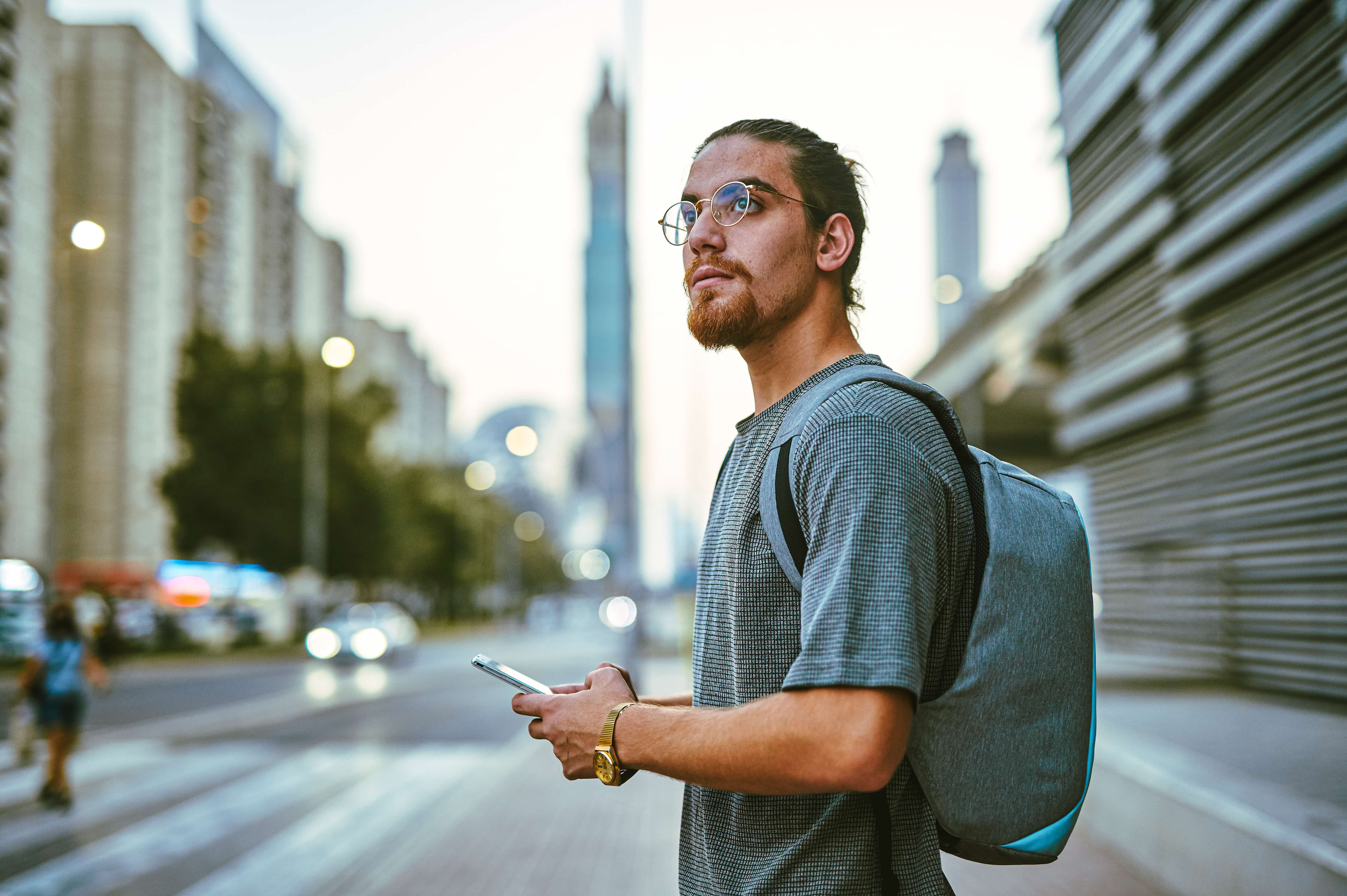 man in the street, holding a phone