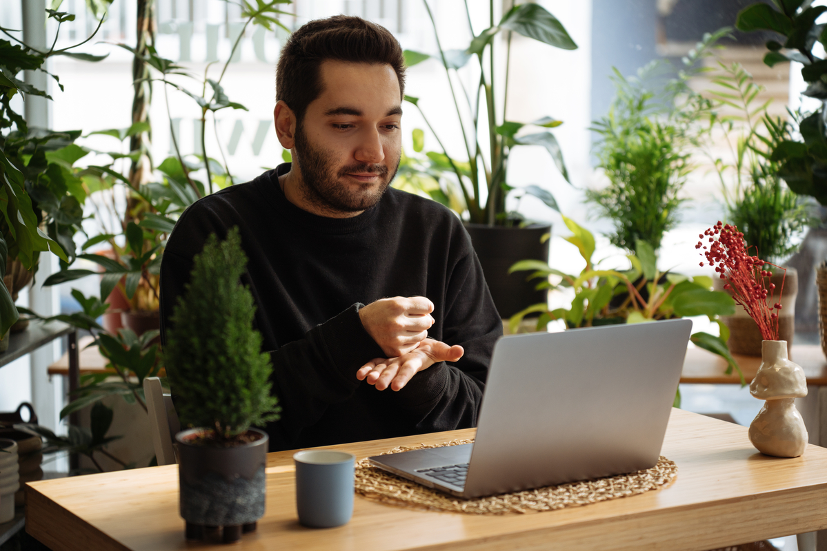 Man using sign language while on a video meeting.