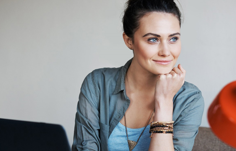 Woman smiling while leaning on her hand