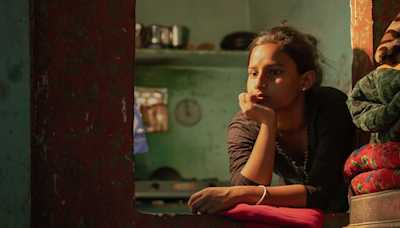 Anjali looking out of a window.