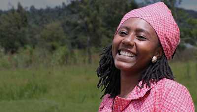 Woman laughing in green field
