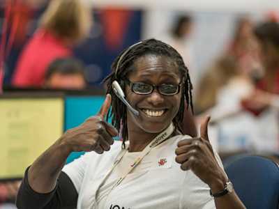 Call centre volunteer giving the double thumbs-up