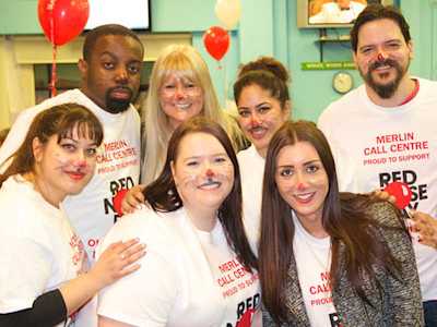 Merlin Entertainment employees in cat facepaint and Red Nose Day t-shirts