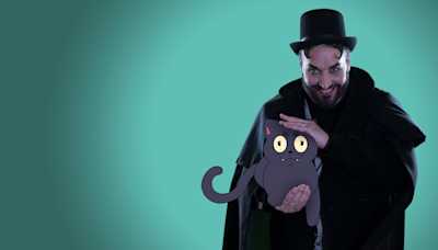 Doomy McGloomy looking mischievous holding a cat.