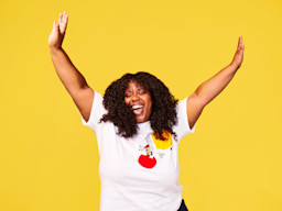Woman smiling and wearing a Red Nose Day t-shirt from TK Maxx.