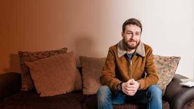 Jordan sitting on his sofa