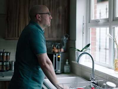 Man staring out of his kitchen window