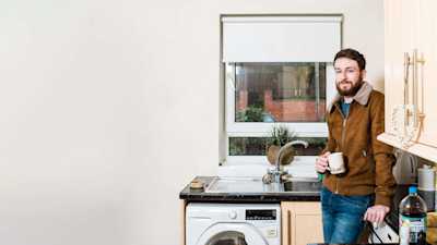 Jordan standing in his kitchen