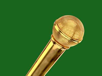 Gold microphone on green background