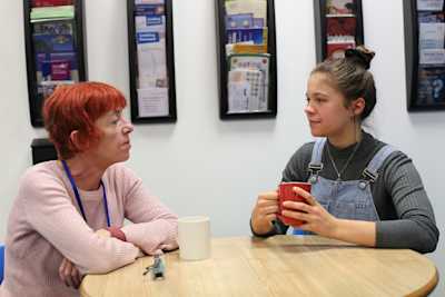 Two women drinking coffee