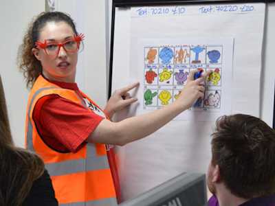 Invesco employee waring silly Red Nose Day glasses