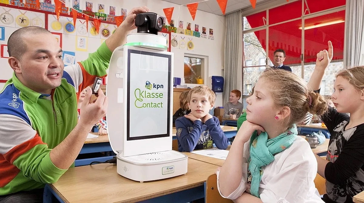 Beeldscherm in de klas met kinderen, met op het scherm een logo van KPN en de tekst: ‘KlasseContact’.