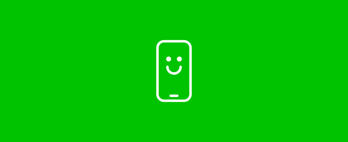 Een telefoon met een smiley op een groene achtergrond