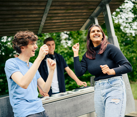 Teenagers dancing and enjoying music in front of the Fono Interactive DJ booth