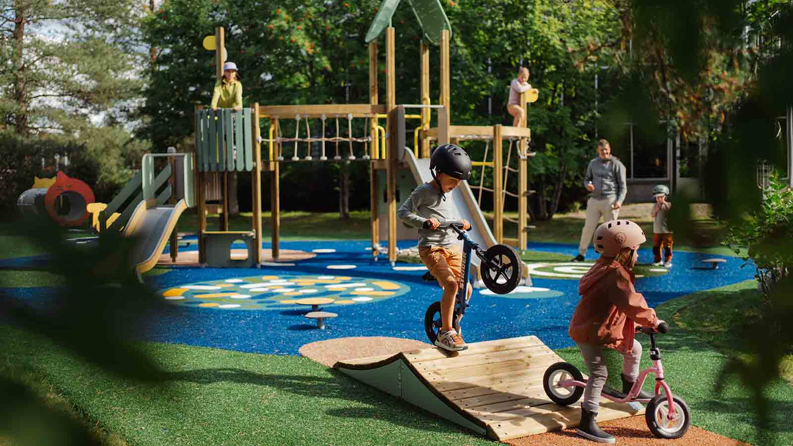 Children biking on a Prime playground on Lappset HQ