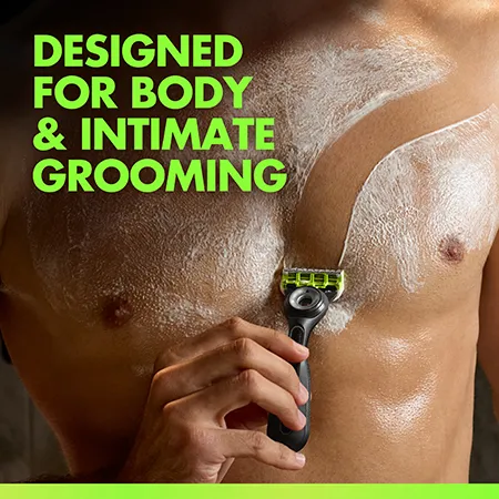 Close-up of a torso with shaving cream while using a razor, with text indicating design for body and intimate grooming.