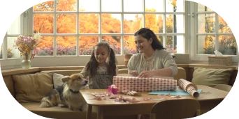 Smiling mother and daughter with pet dog.