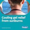 Person with sunburned shoulders at the beach, promoting BENADRYL®  cooling gel for sunburn relief. Text reads 'Cooling gel relief from sunburns'. 