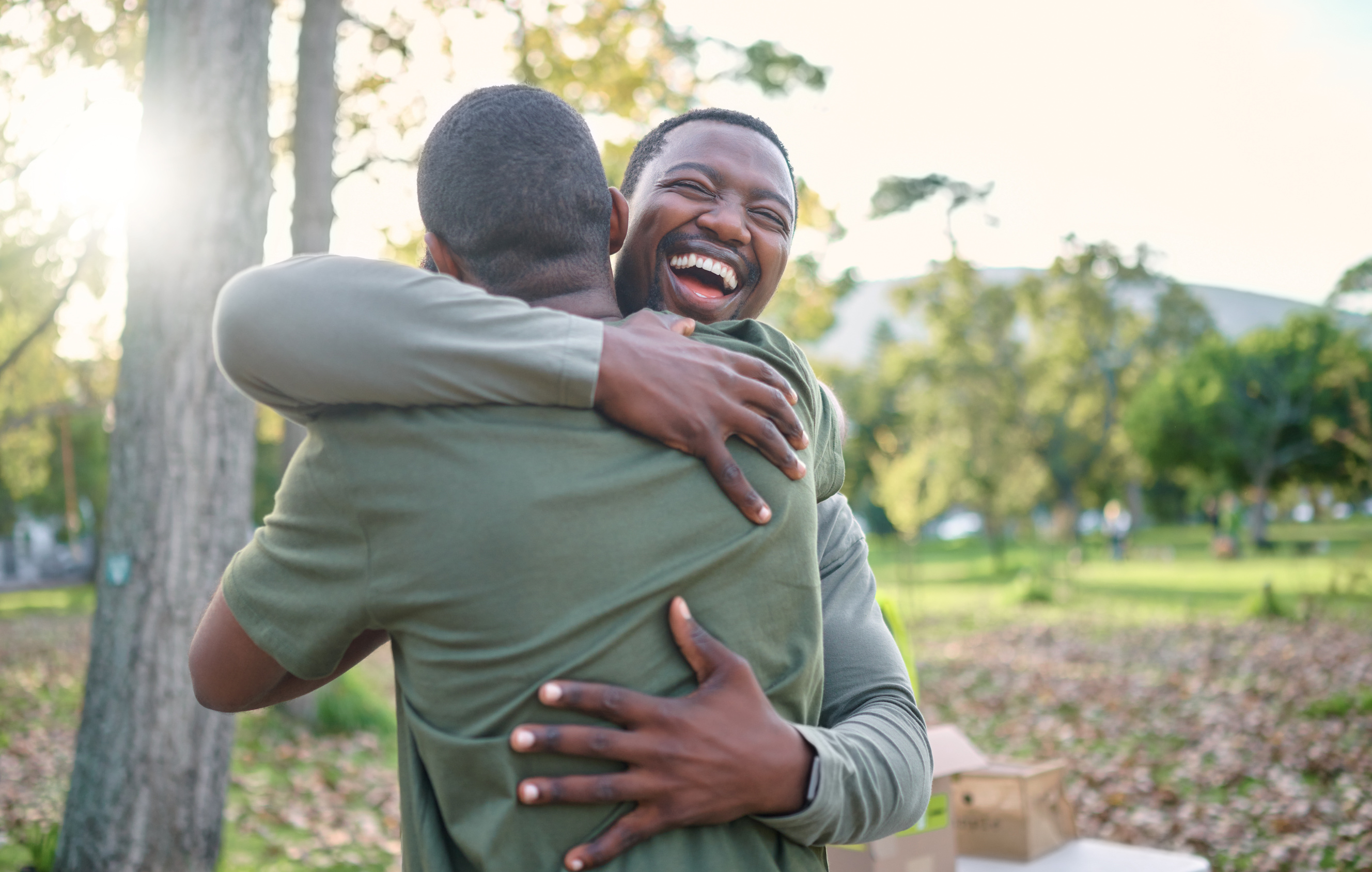 Two friends hugging and laughing.