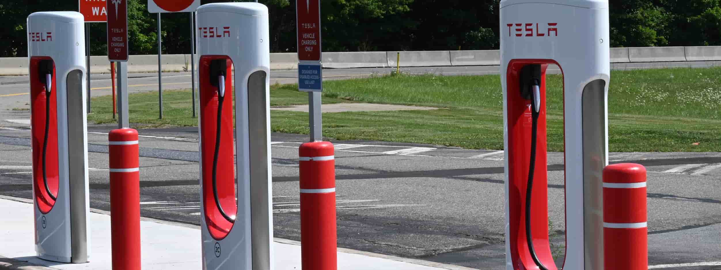A line of Tesla Superchargers await EV drivers who need to recharge their vehicles.
