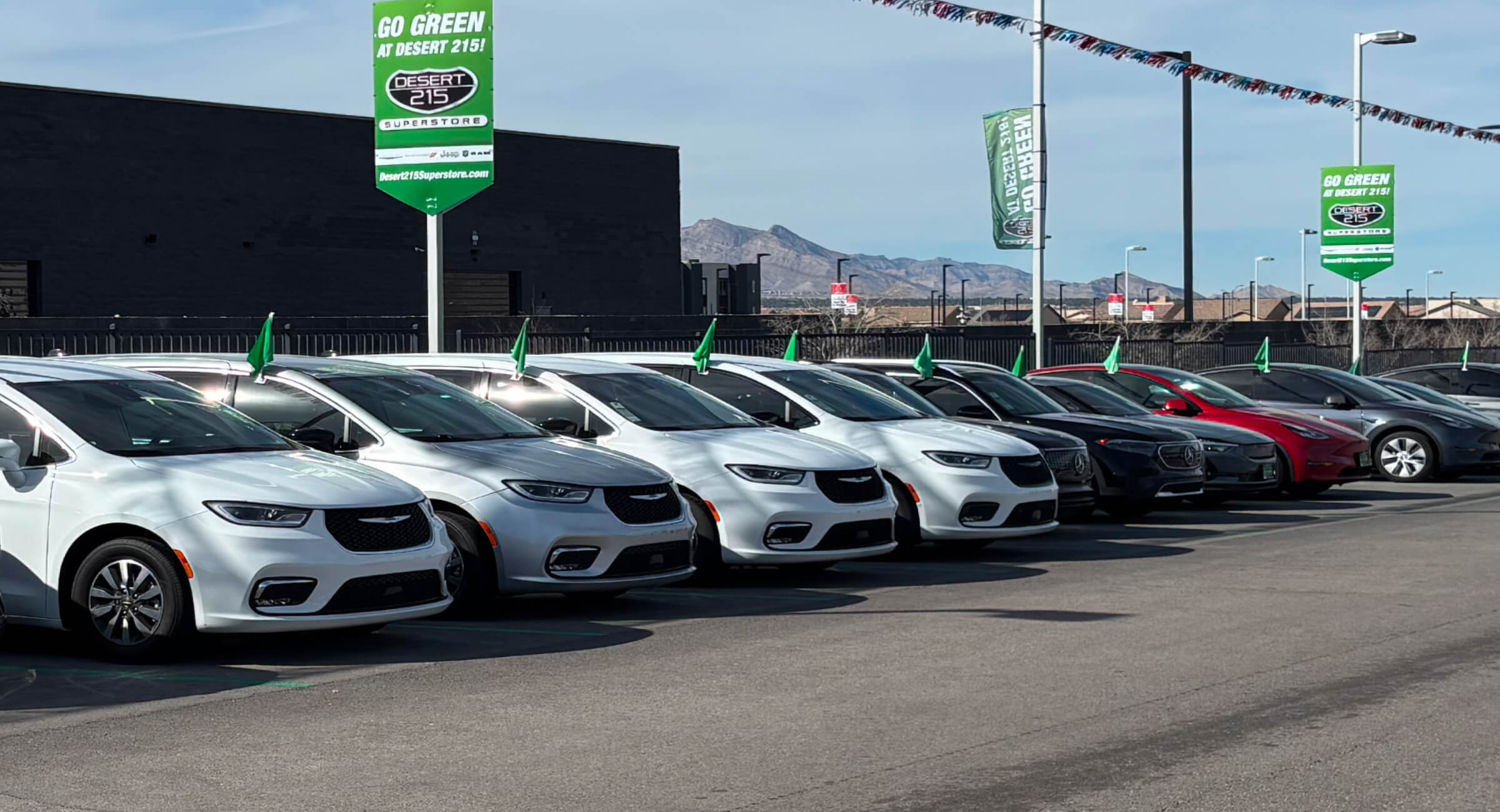 A row of used electric vehicles (EVs) for sale at a dealership. 